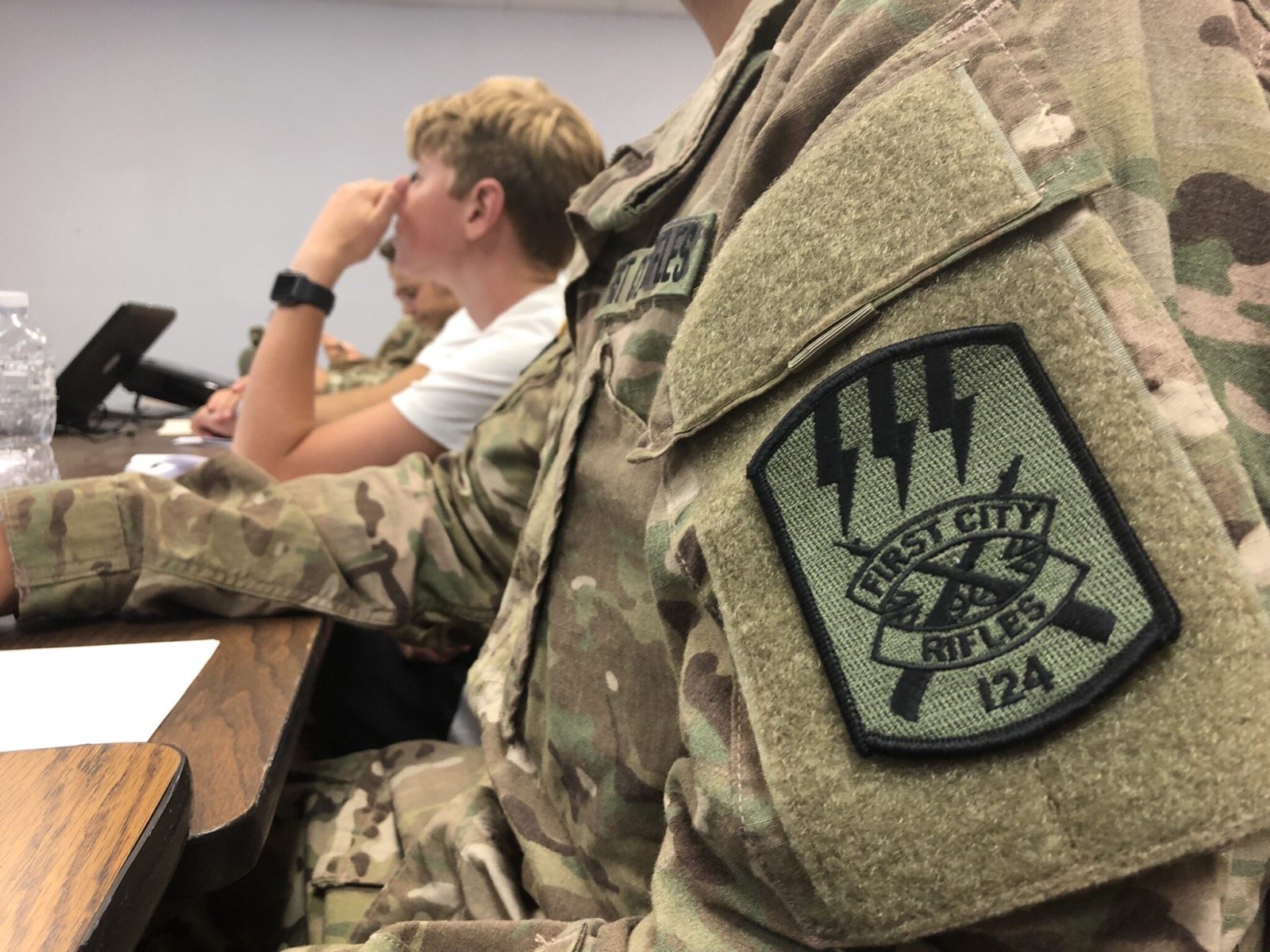 Close-up of the First City Rifles 124 shoulder patch worn during classroom instruction